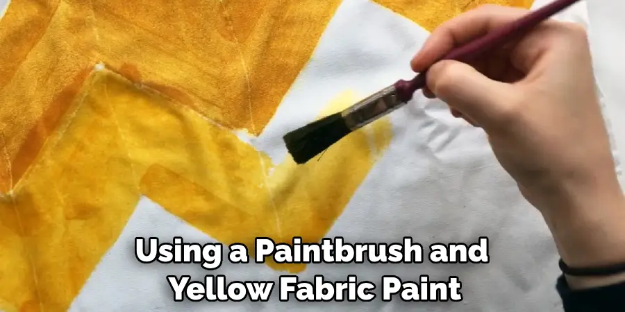 Using a Paintbrush and Yellow Fabric Paint