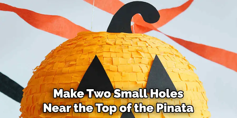Make Two Small Holes Near the Top of the Pinata
