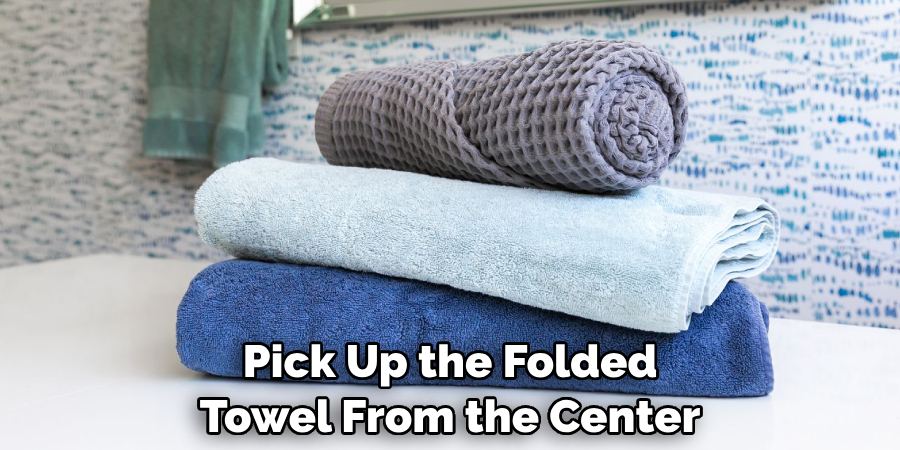 Pick Up the Folded Towel From the Center
