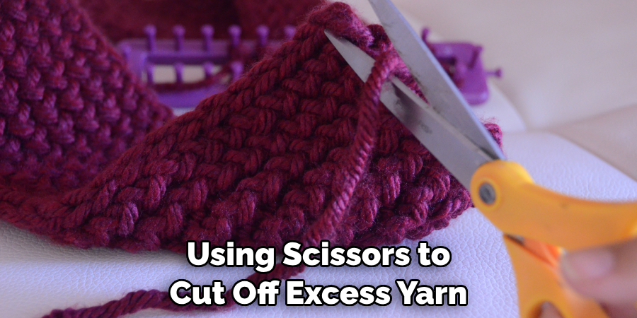Using Scissors to Cut Off Excess Yarn