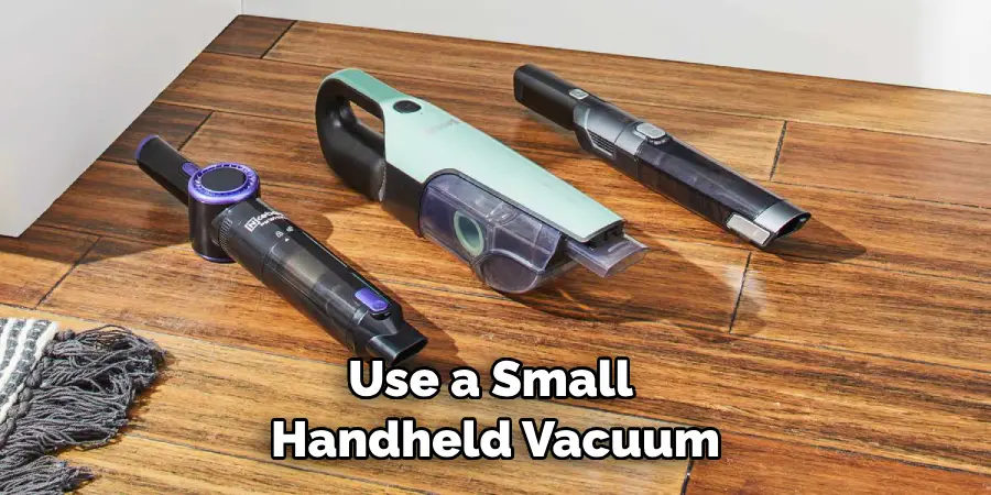 Use a Small Handheld Vacuum