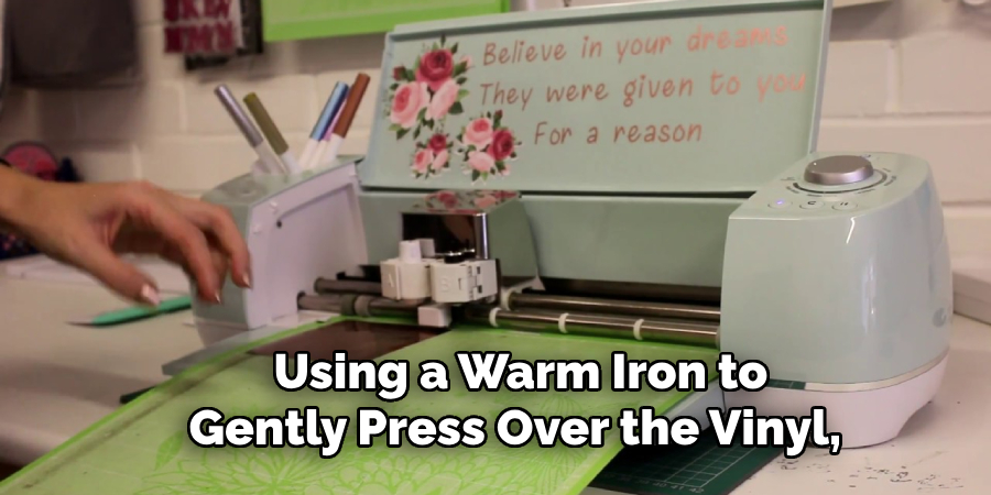  Using a Warm Iron to Gently Press Over the Vinyl,