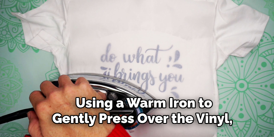  Using a Warm Iron to Gently Press Over the Vinyl,