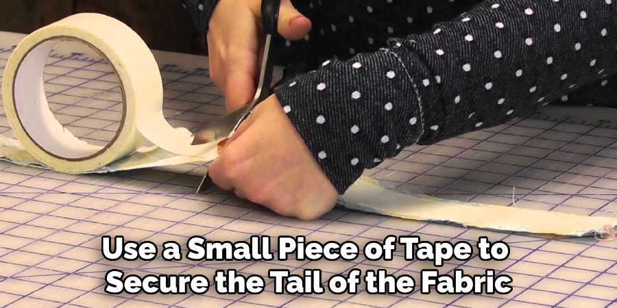 Use a Small Piece of Tape to Secure the Tail of the Fabric