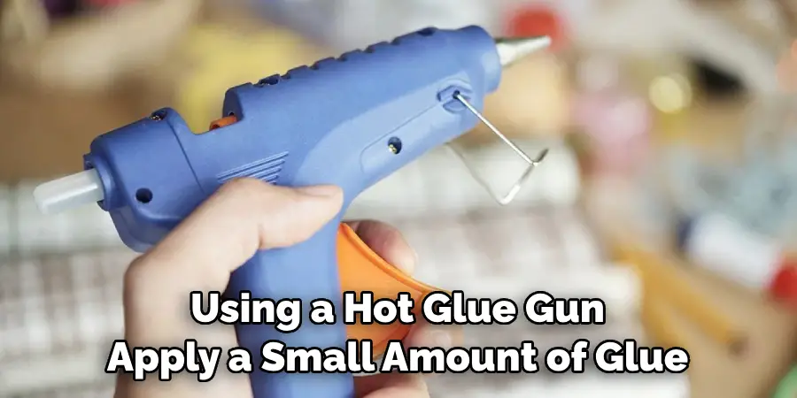 Using a Hot Glue Gun Apply a Small Amount of Glue