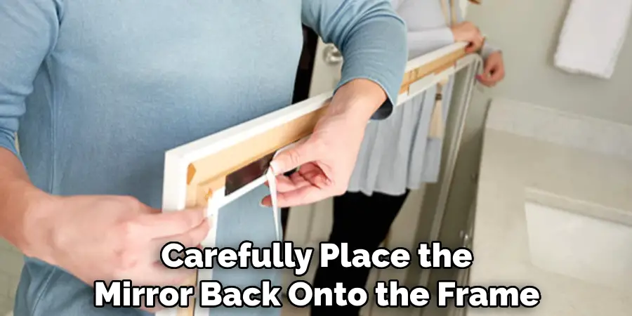 Carefully Place the Mirror Back Onto the Frame