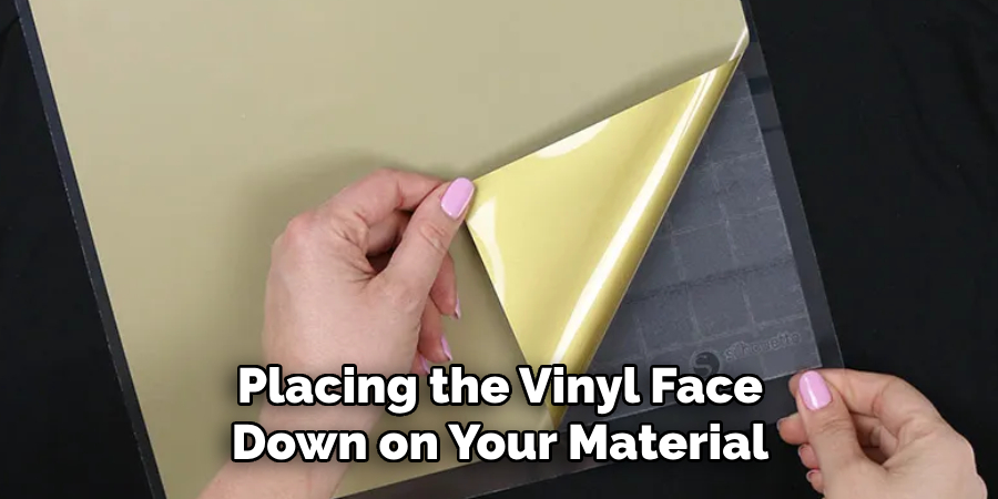 Placing the Vinyl Face Down on Your Material