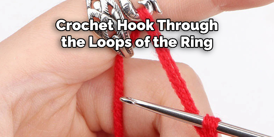 Crochet Hook Through
the Loops of the Ring