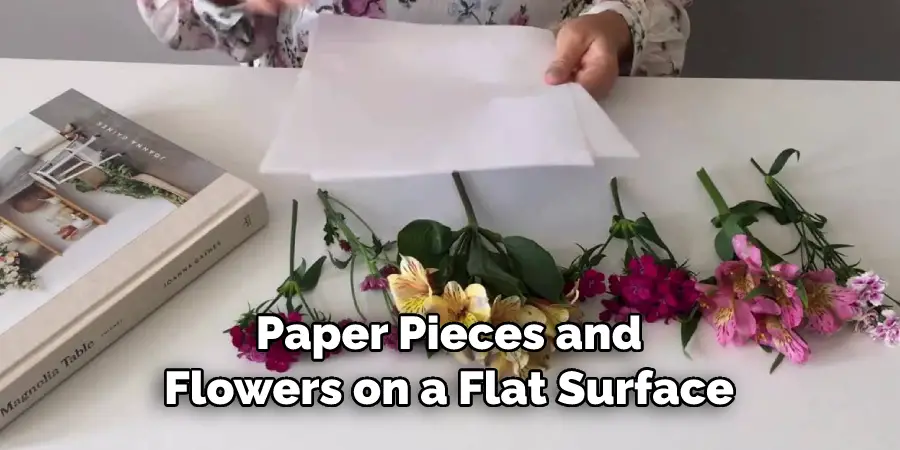 Paper Pieces and Flowers on a Flat Surface