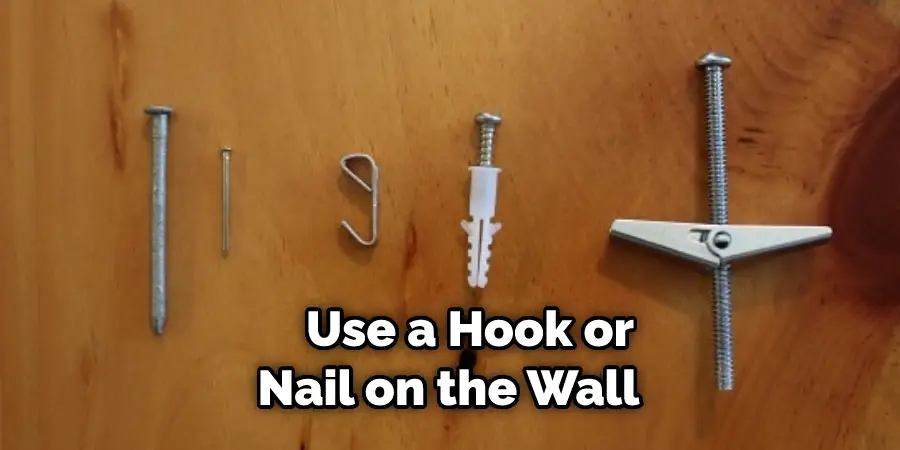 Use a Hook or Nail on the Wall