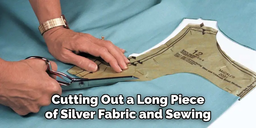 Cutting Out a Long Piece of Silver Fabric and Sewing